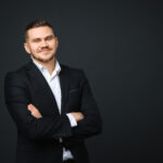 man wearing a black suit in a black background