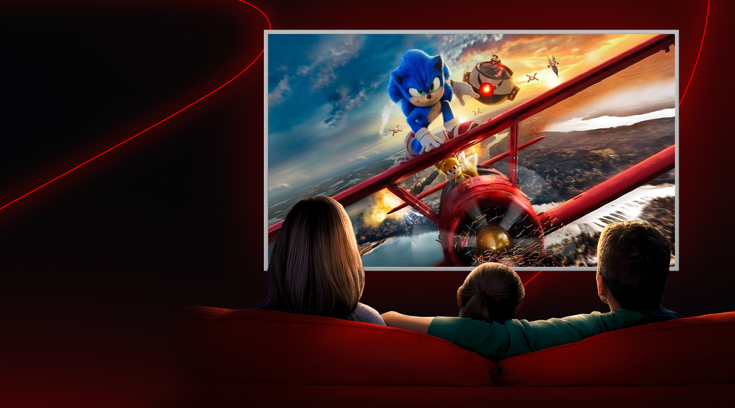 a family looking at a tv screen