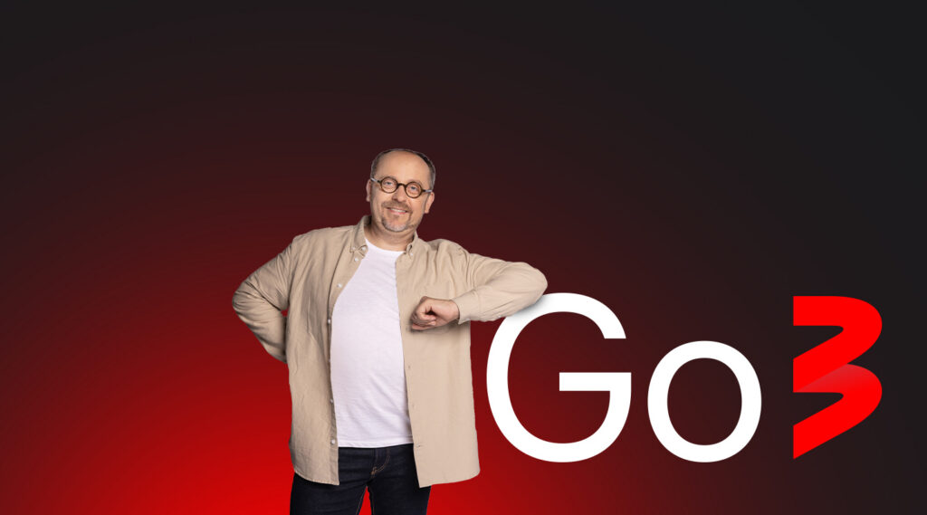 man standing next to go3 sign